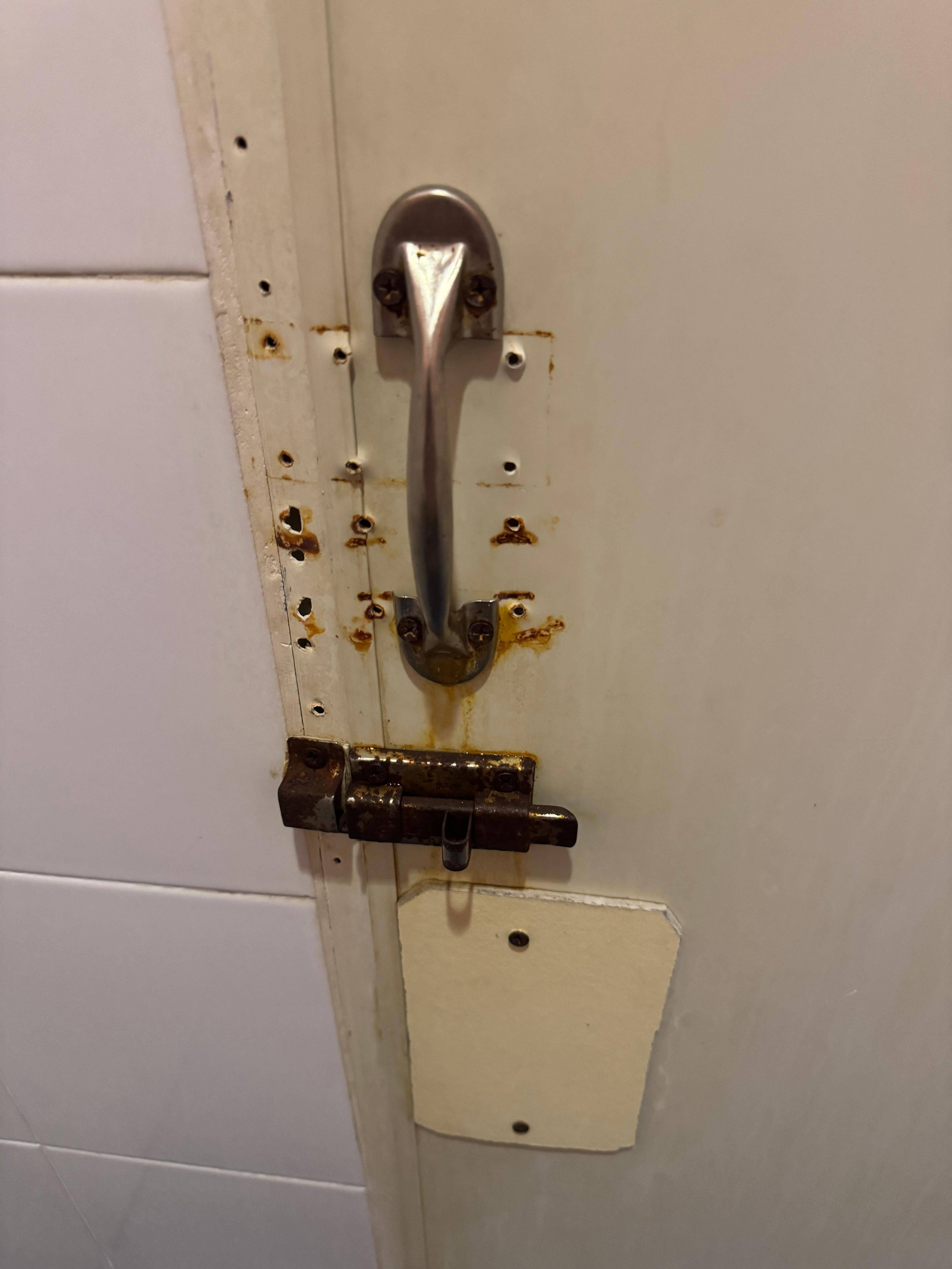 Door to bathroom - looks like they made many attempts to fix but it still doesn’t really work
