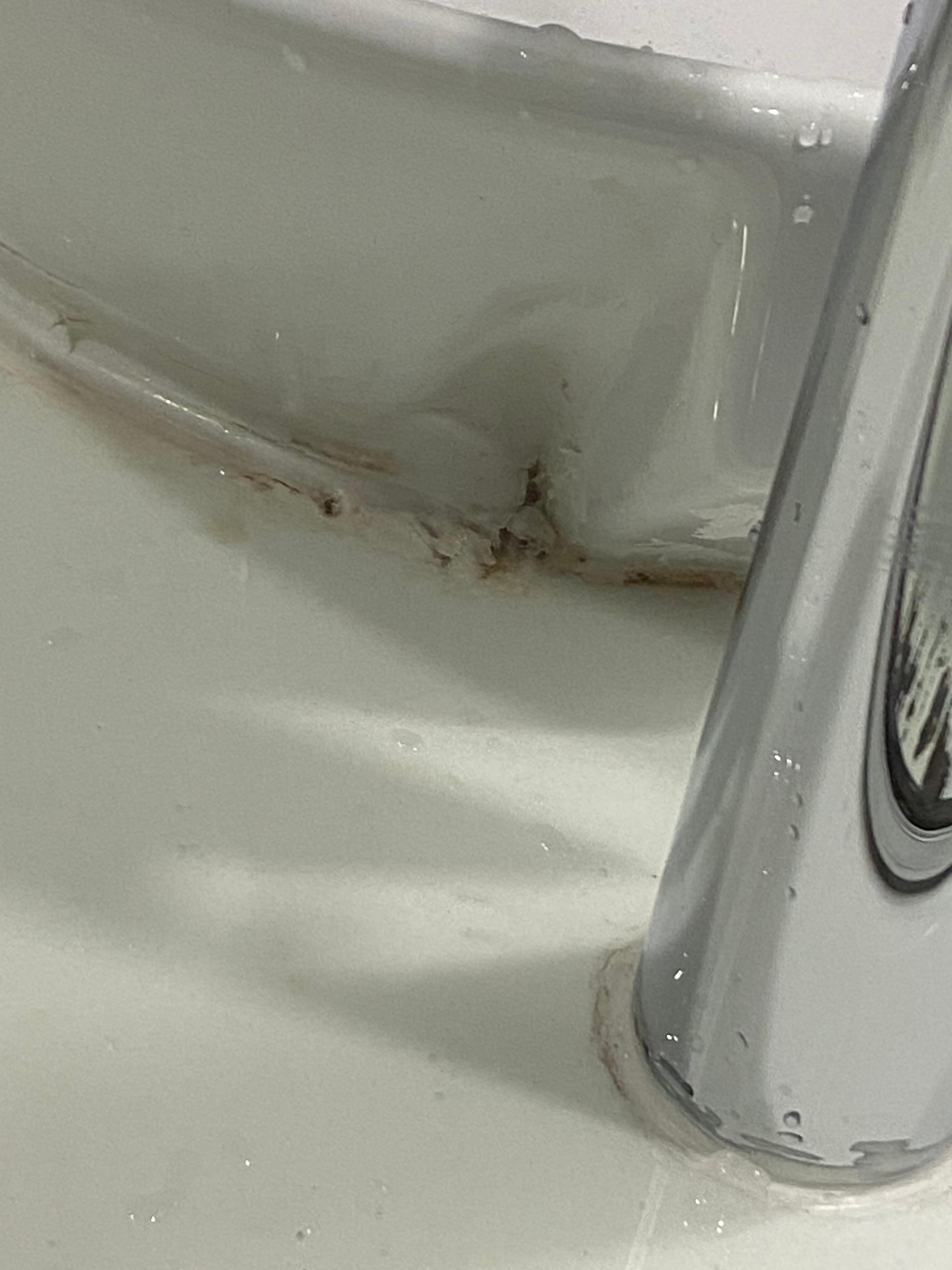 Behind bathroom sink as seen in the mirror. 