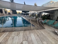 A sad excuse for a hotel pool — surrounded by a ragged rope fence like a crime scene, filthy tiles, and broken loungers. Nothing inviting here, unless you’re a fan of disappointment