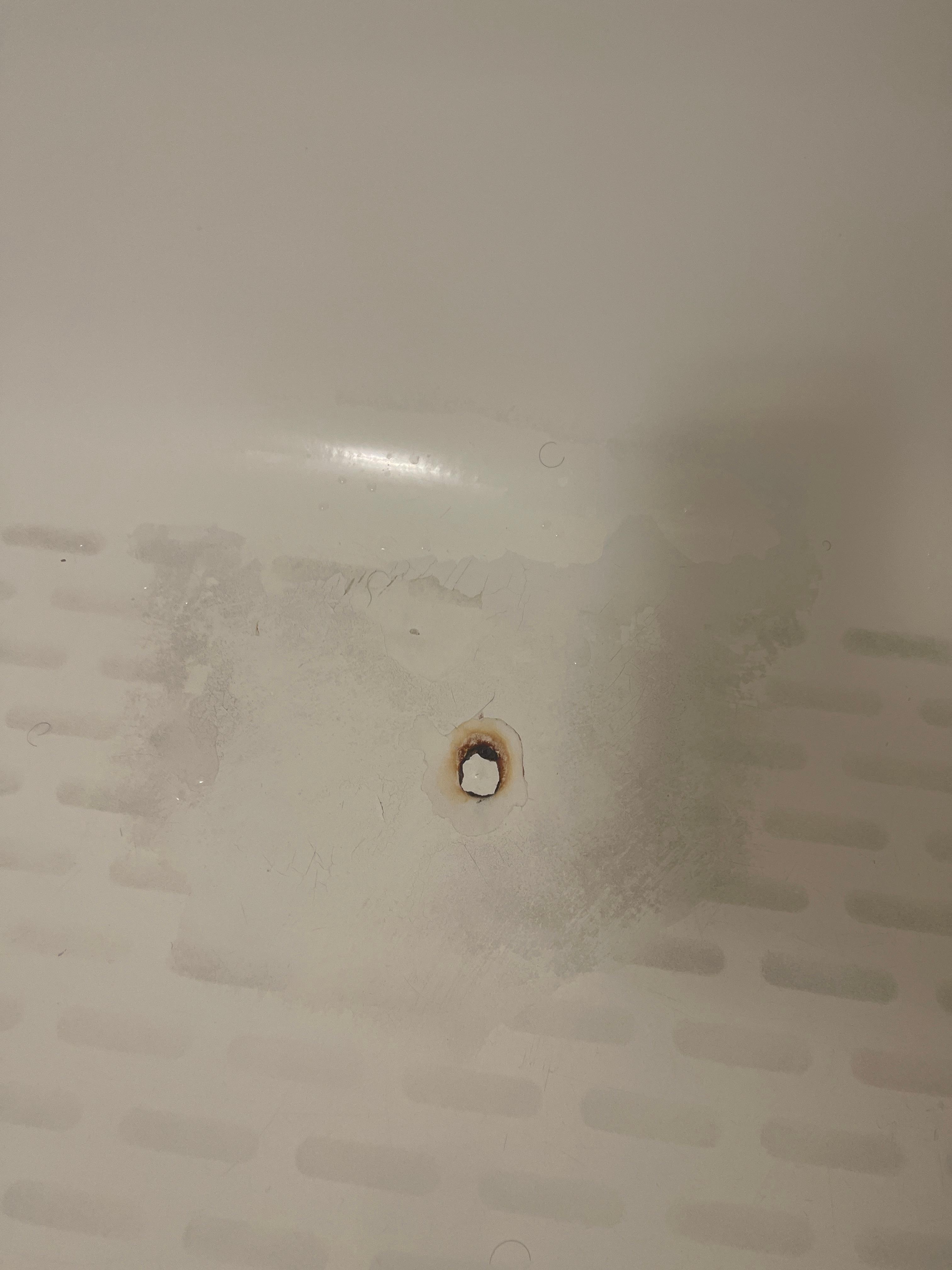Rusty hole in tub