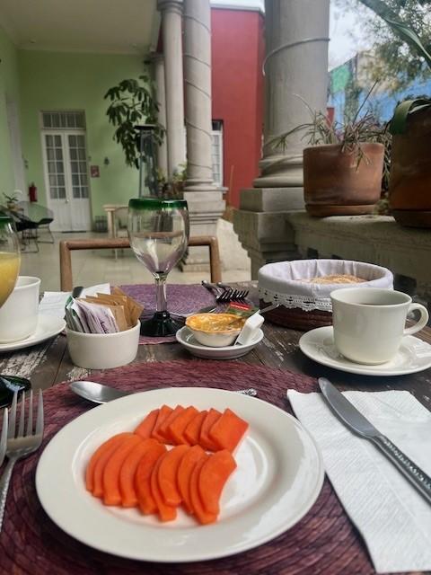 Breakfast on the porch / courtyard of Casa Moctezuma.  Fresh Papaya, bread, passion fruit, etc.  