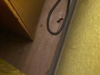 Dirt on the floor between the bed and nightstand