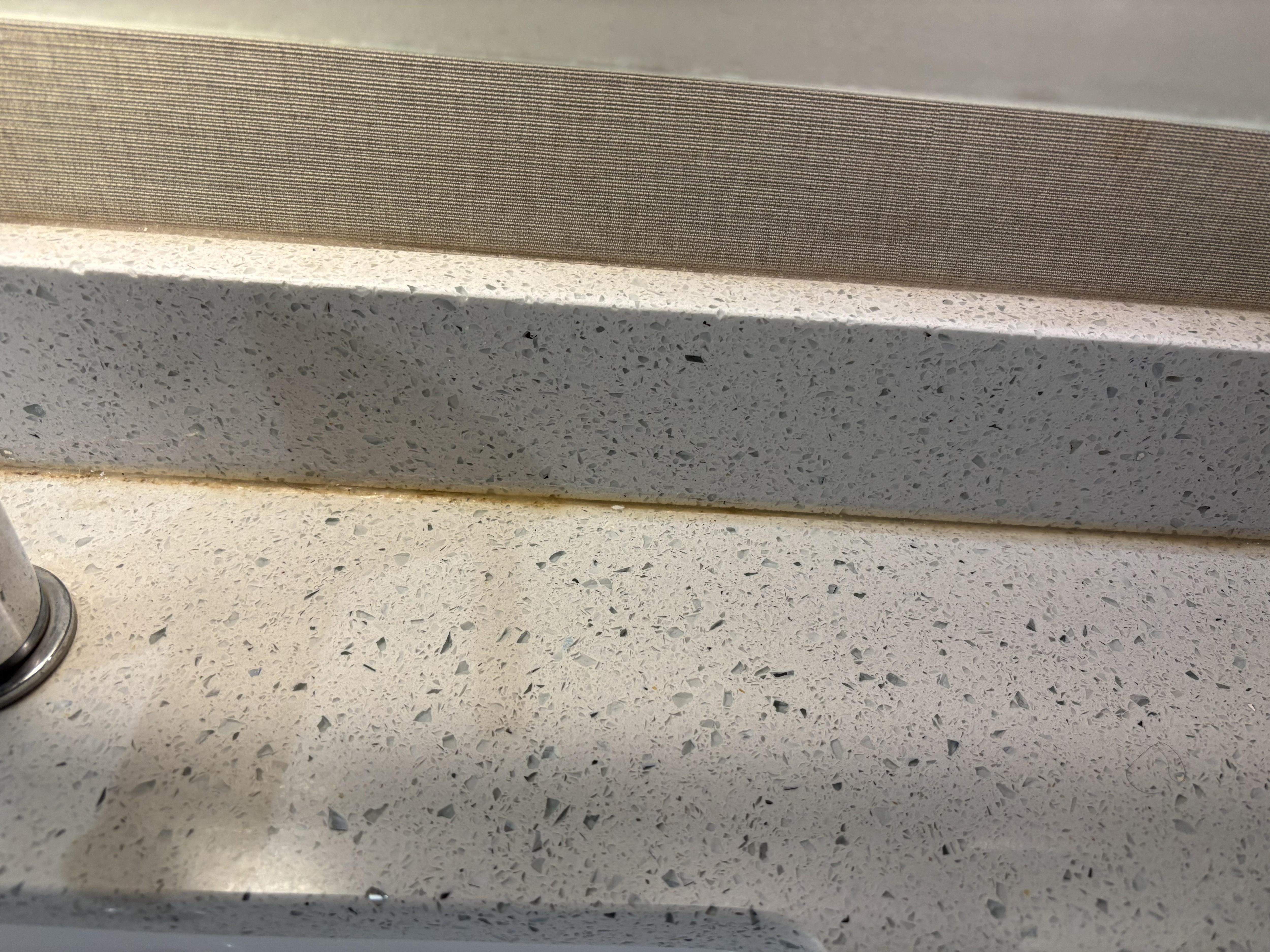 Calk behind sink stained brown