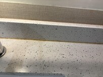 Calk behind sink stained brown