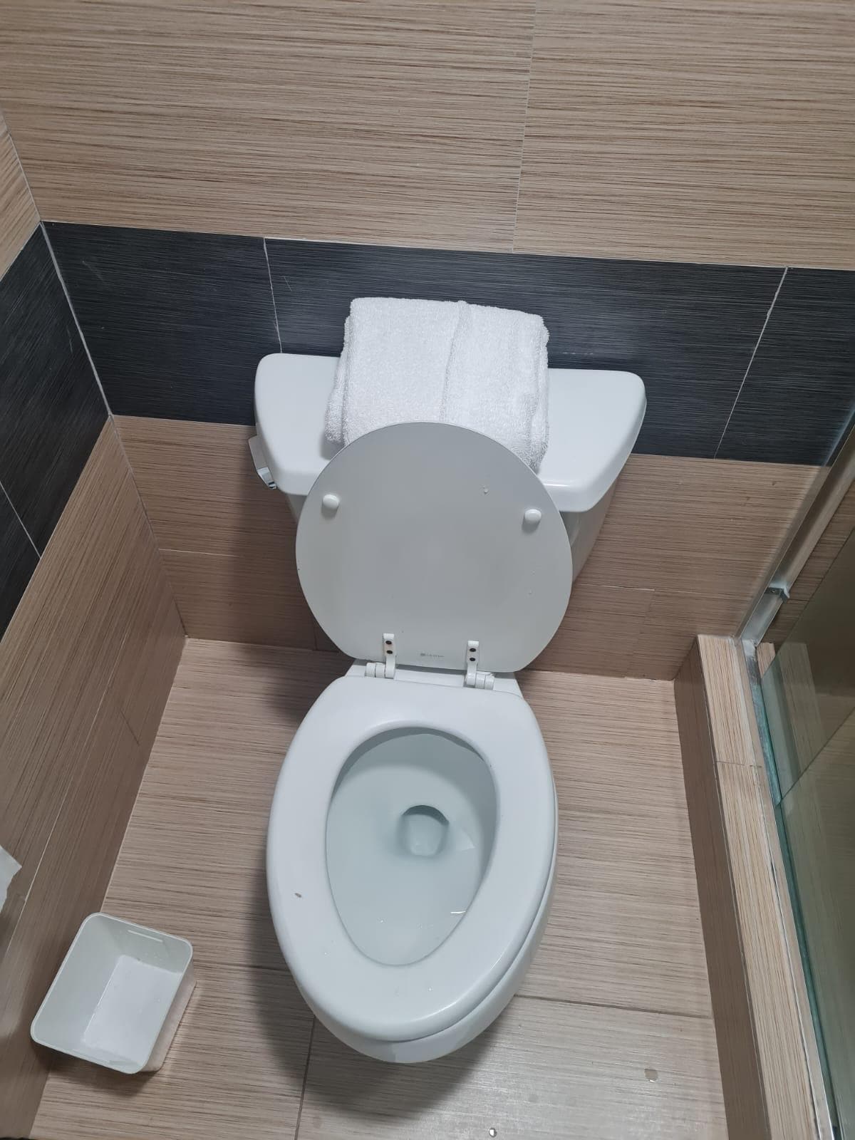 See towels were placed on toilet top.