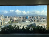 Balcony overlooking highway and mountain.