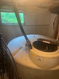 Holding tank for house water, including the tap water for drinking? Note the open window and open top on the tank.