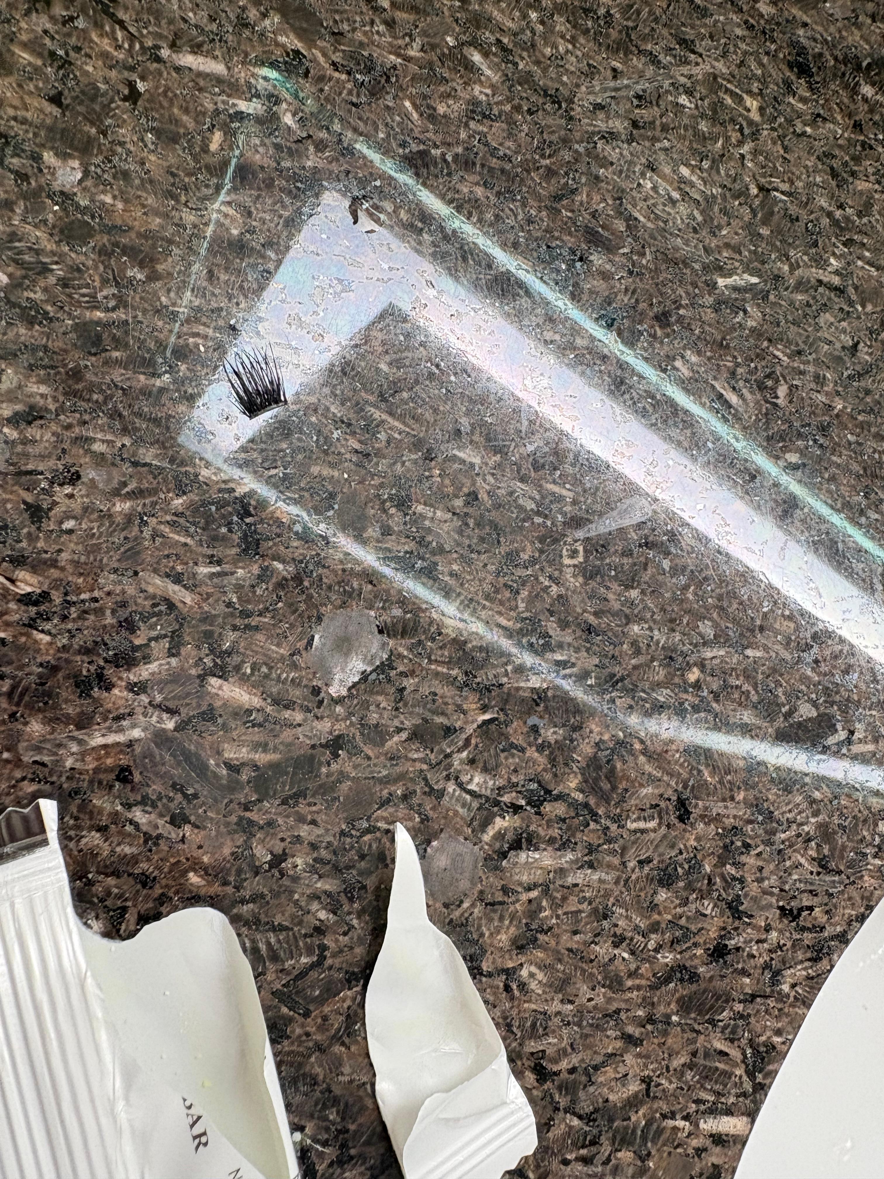 Fake eyelashes stuck to counter