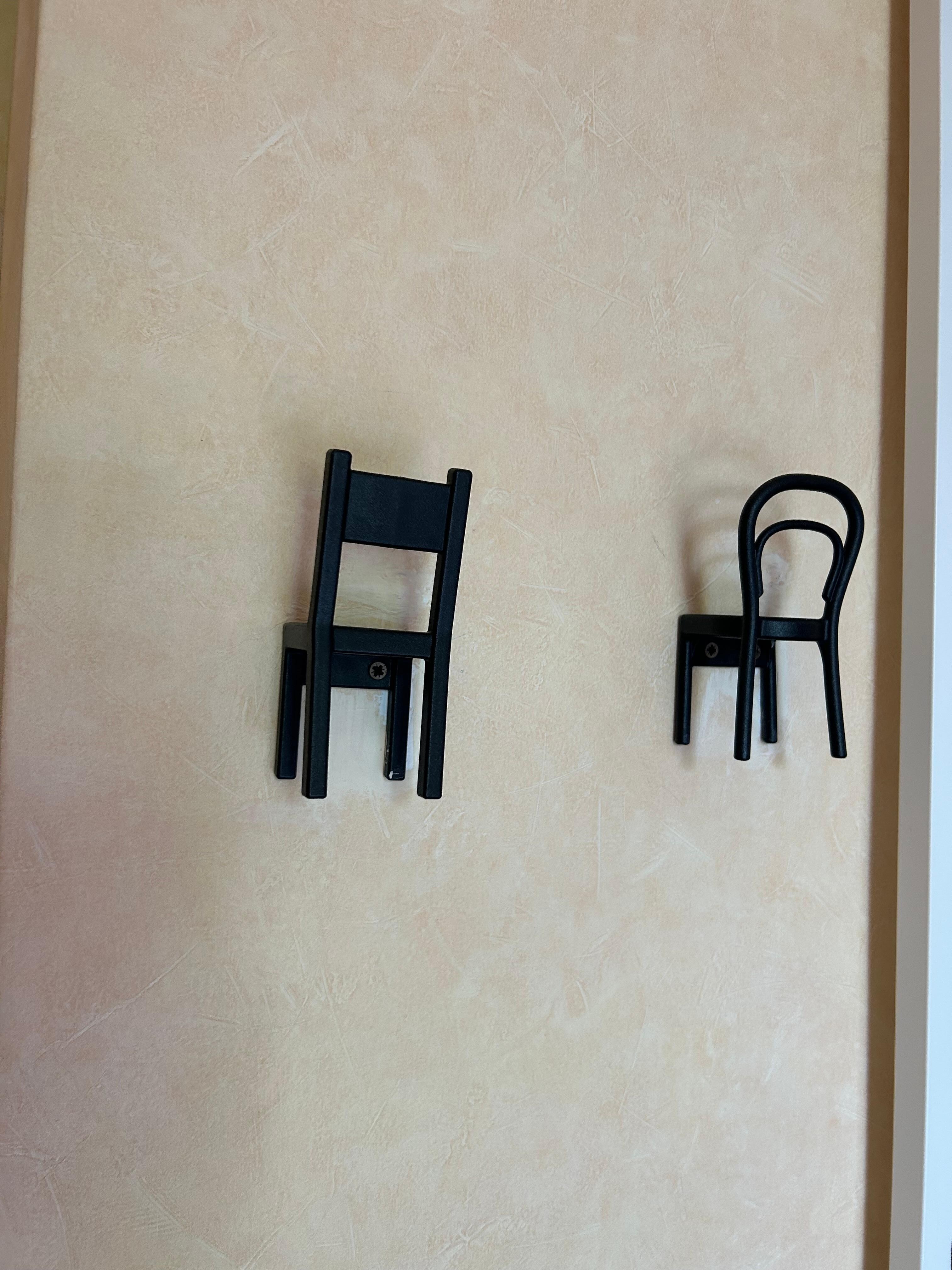These are "hooks" for you to hang your coat or purse on.  Very cute.