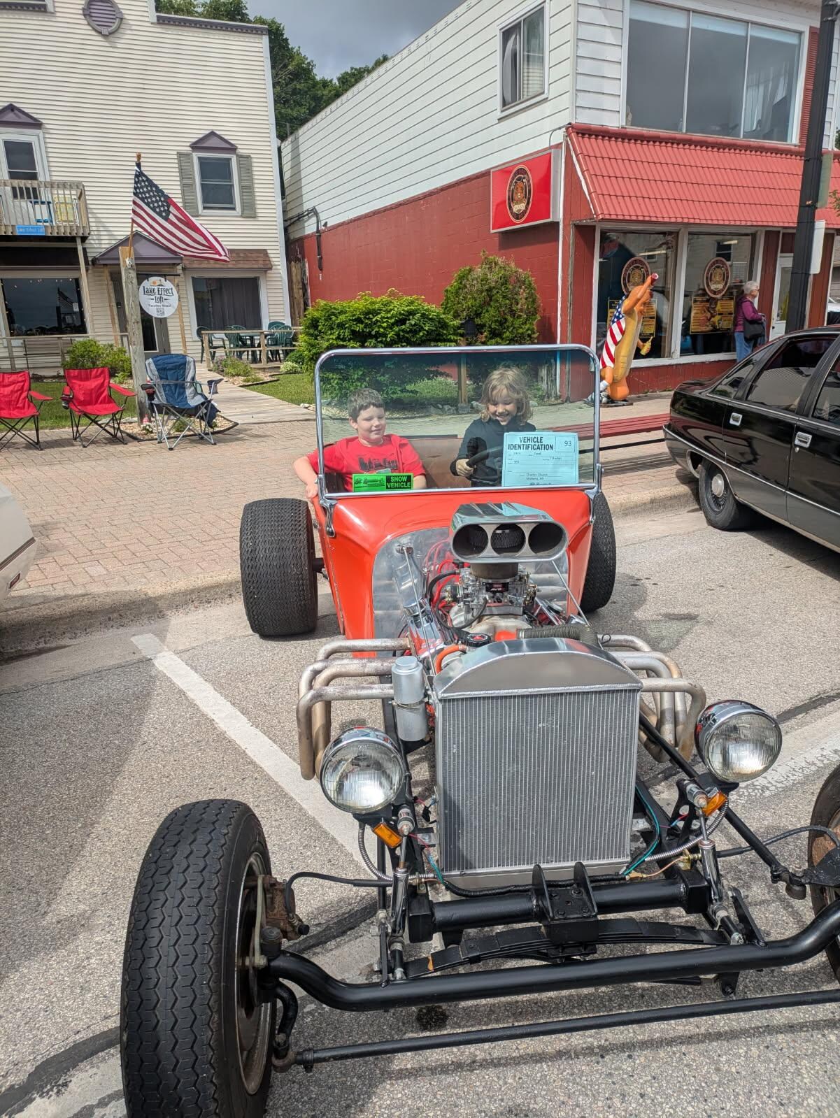 Our little 9 year old Braedyn hosting other kids getting their pics. In the t bucket. Boy did that car draw a crowd the entire day.