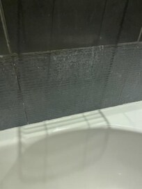 No tiles on the wall in the bathroom