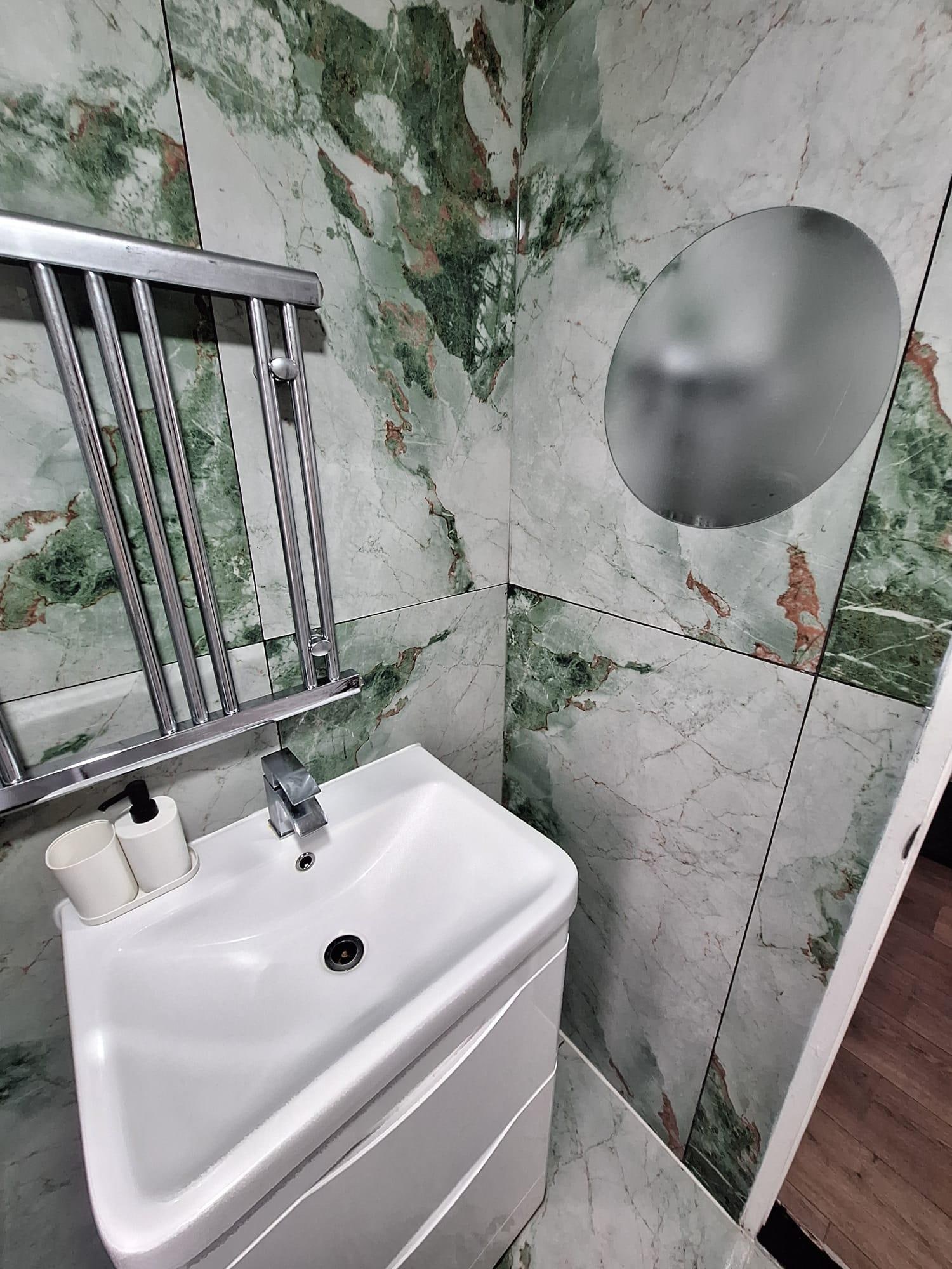 Bathroom - Towel raditor fitted wrong. Hard to use mirror