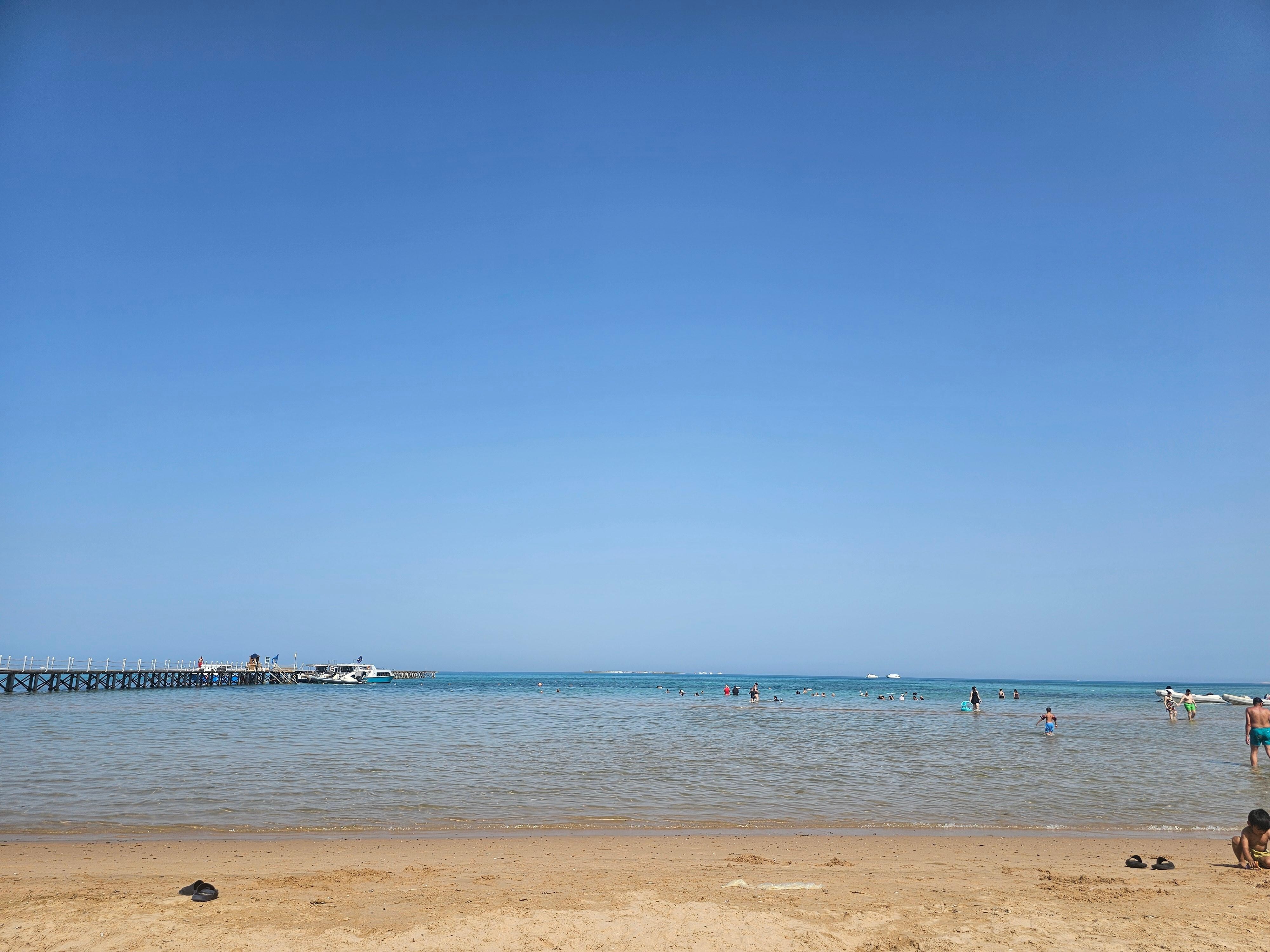 Sandy beach, few fishes not enough for snorkeling. 