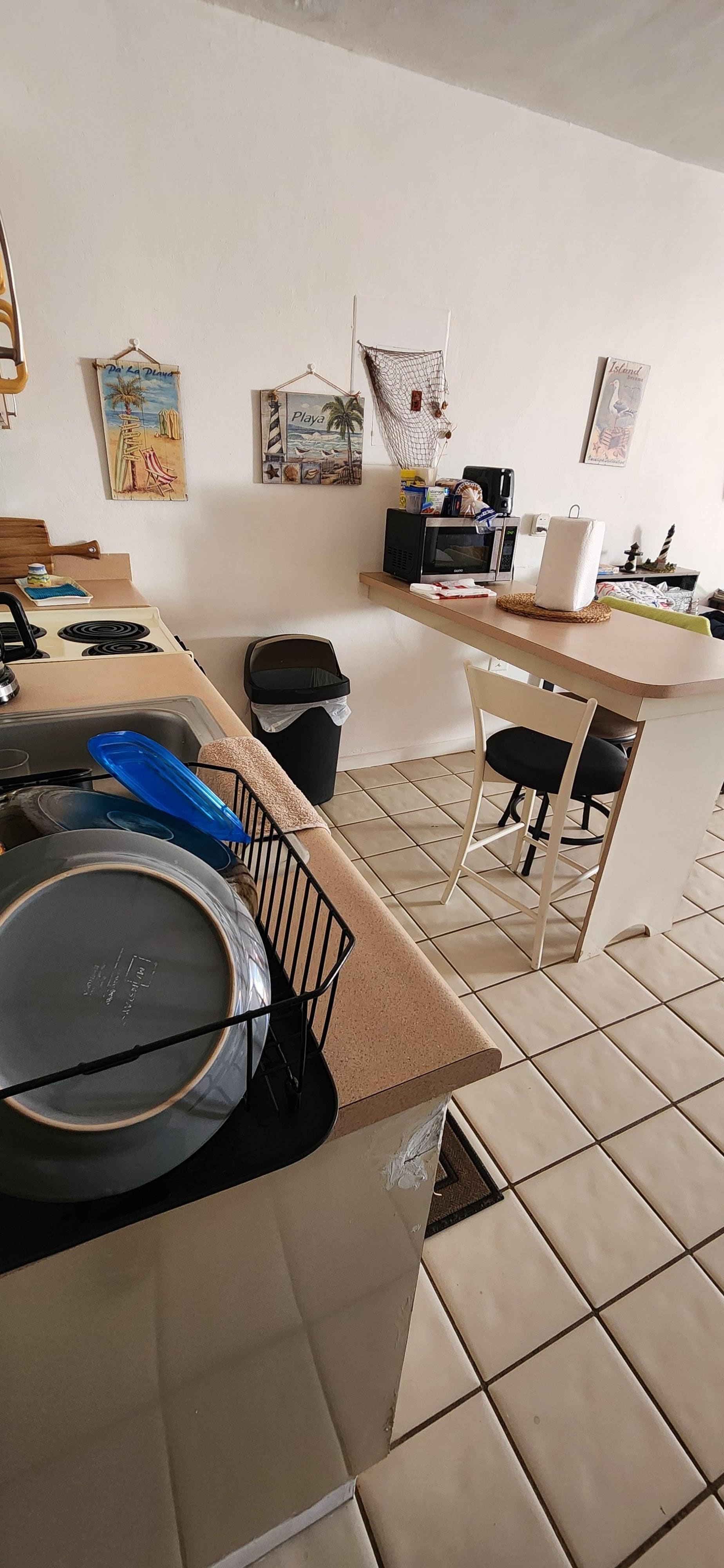 Perfect clean kitchen with full fridge and stove. 