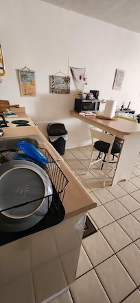 Perfect clean kitchen with full fridge and stove.