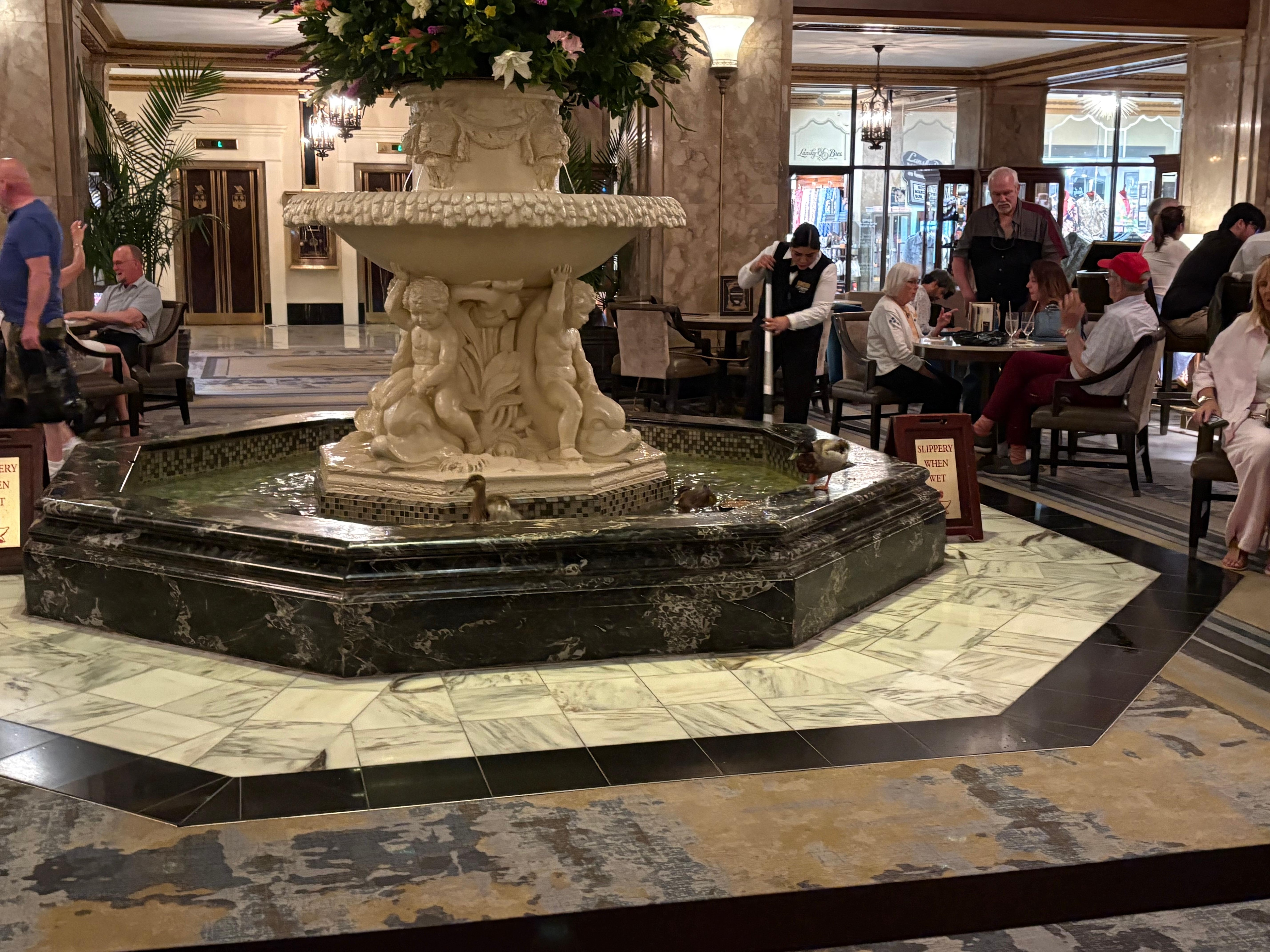 The hotel lobby has a bar, a fountain, and ducks.