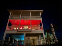 nighttime view of the house from the pool