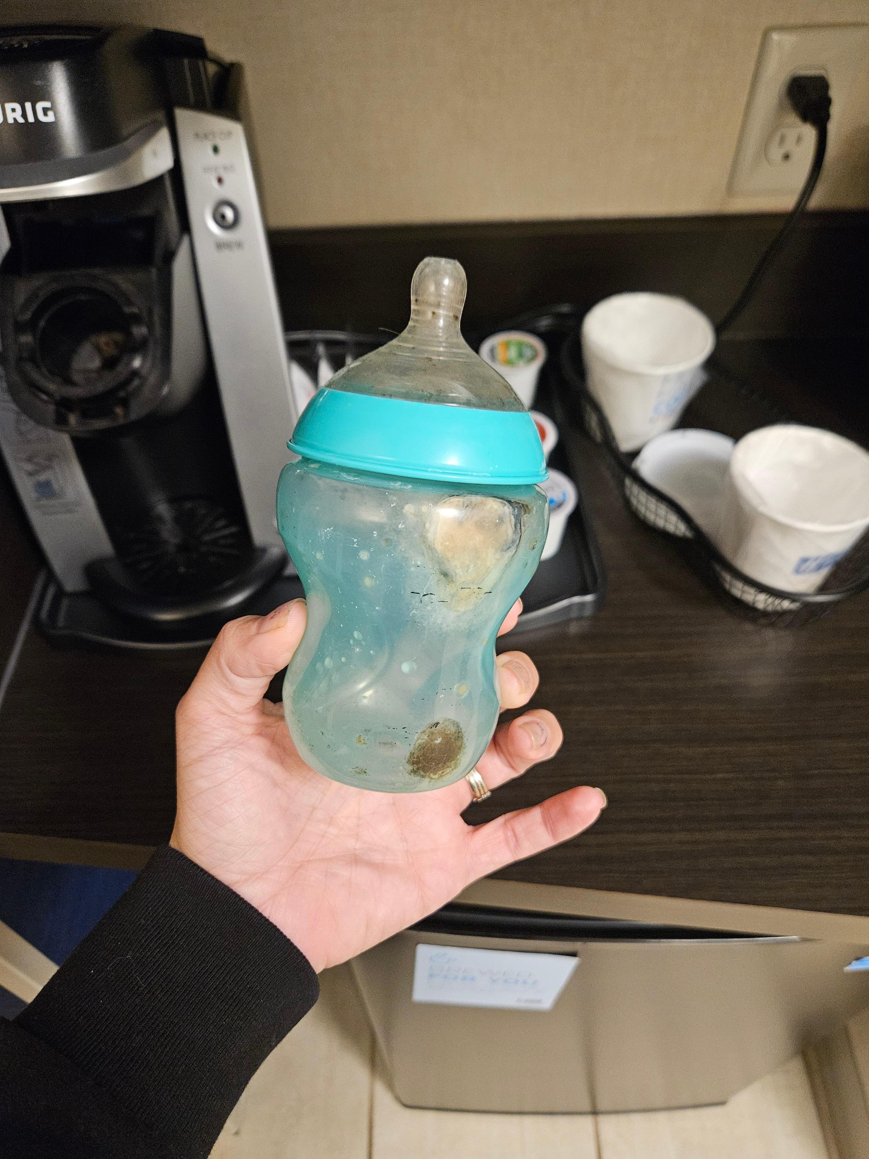 Moldy baby bottle found beside one of the beds
