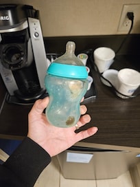 Moldy baby bottle found beside one of the beds