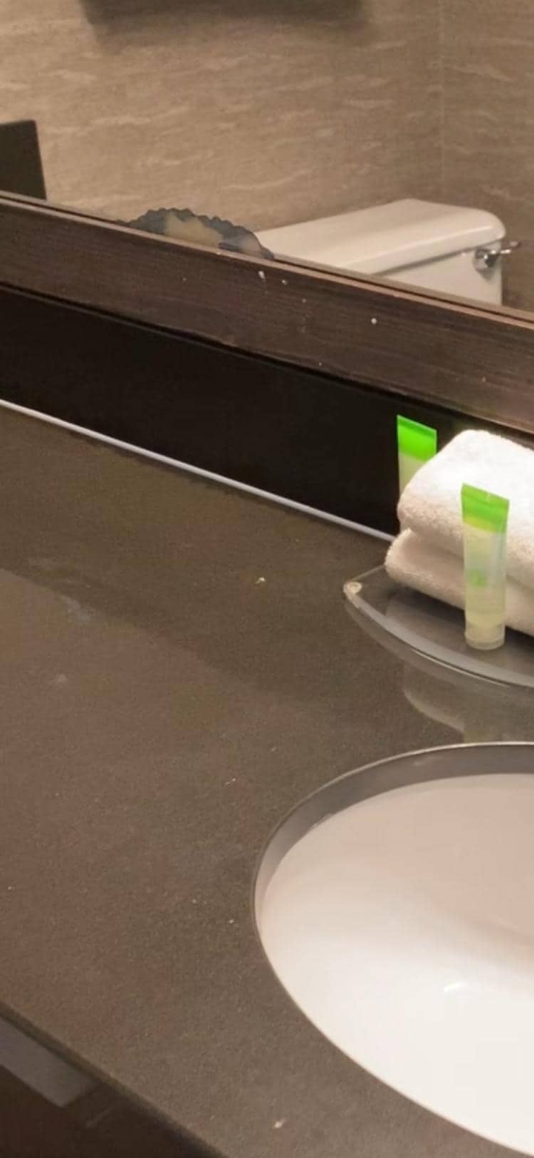 Chipped broken mirror and counter top