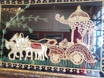 Pictures on the wall are done in pearls and golden thread
