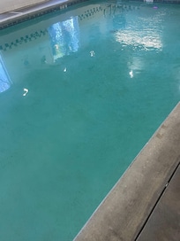 The pool looked like it some algae growing on the bottom giving off a green tinge