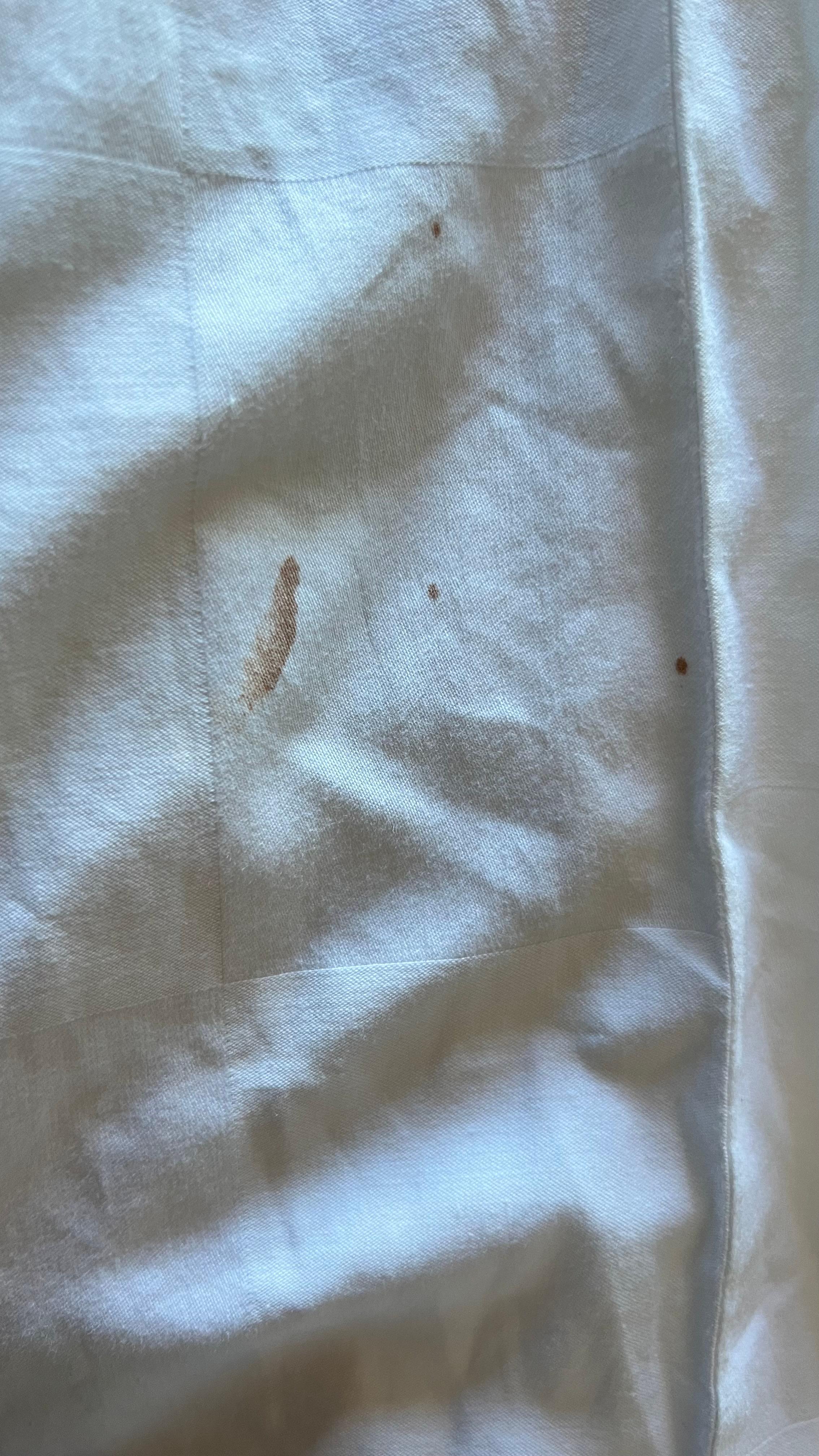 Chocolate and makeup stains on bedsheets from previous guests