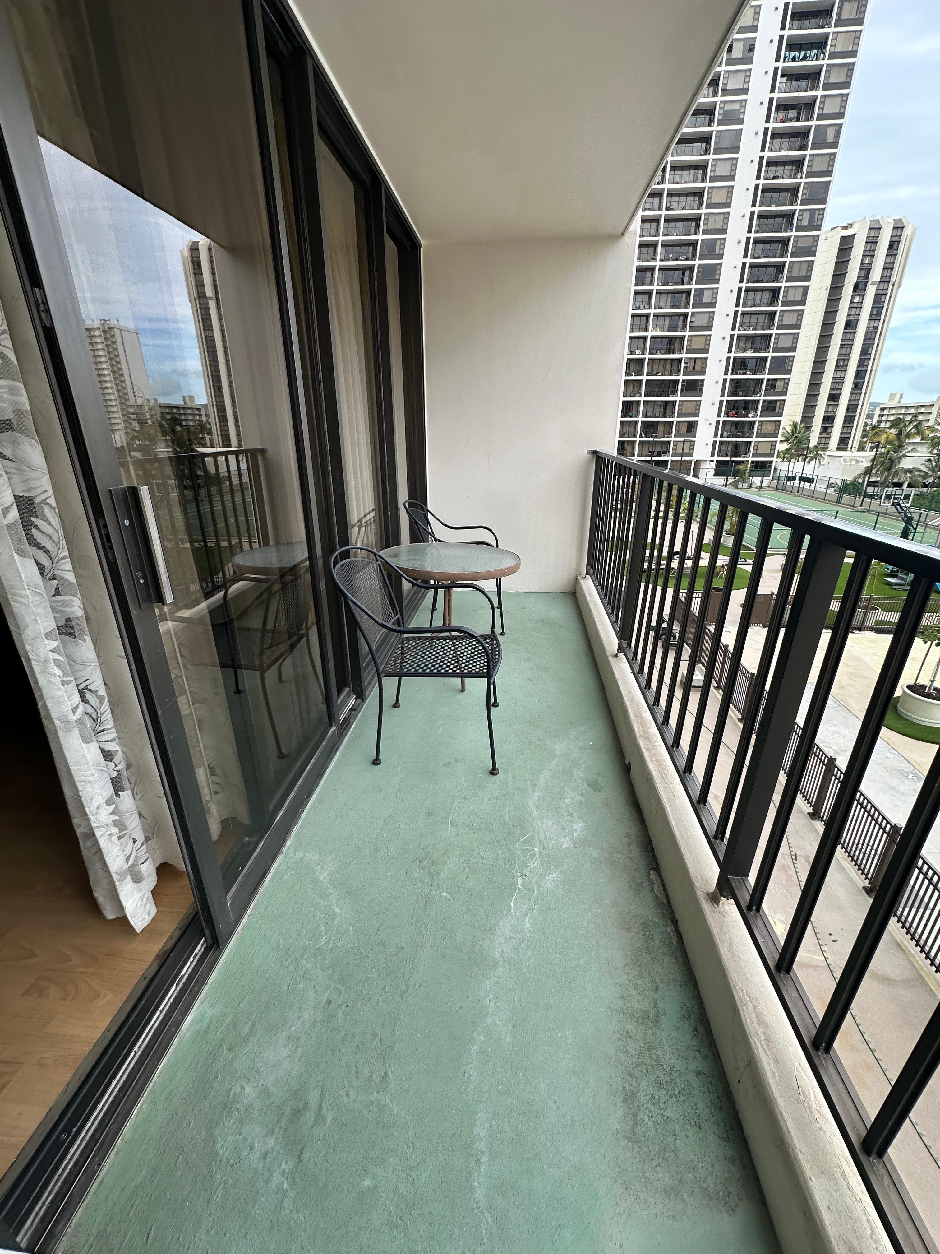 View of balcony with 2 chairs and table