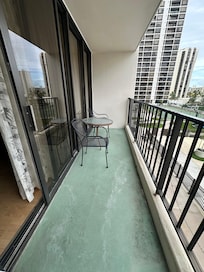 View of balcony with 2 chairs and table
