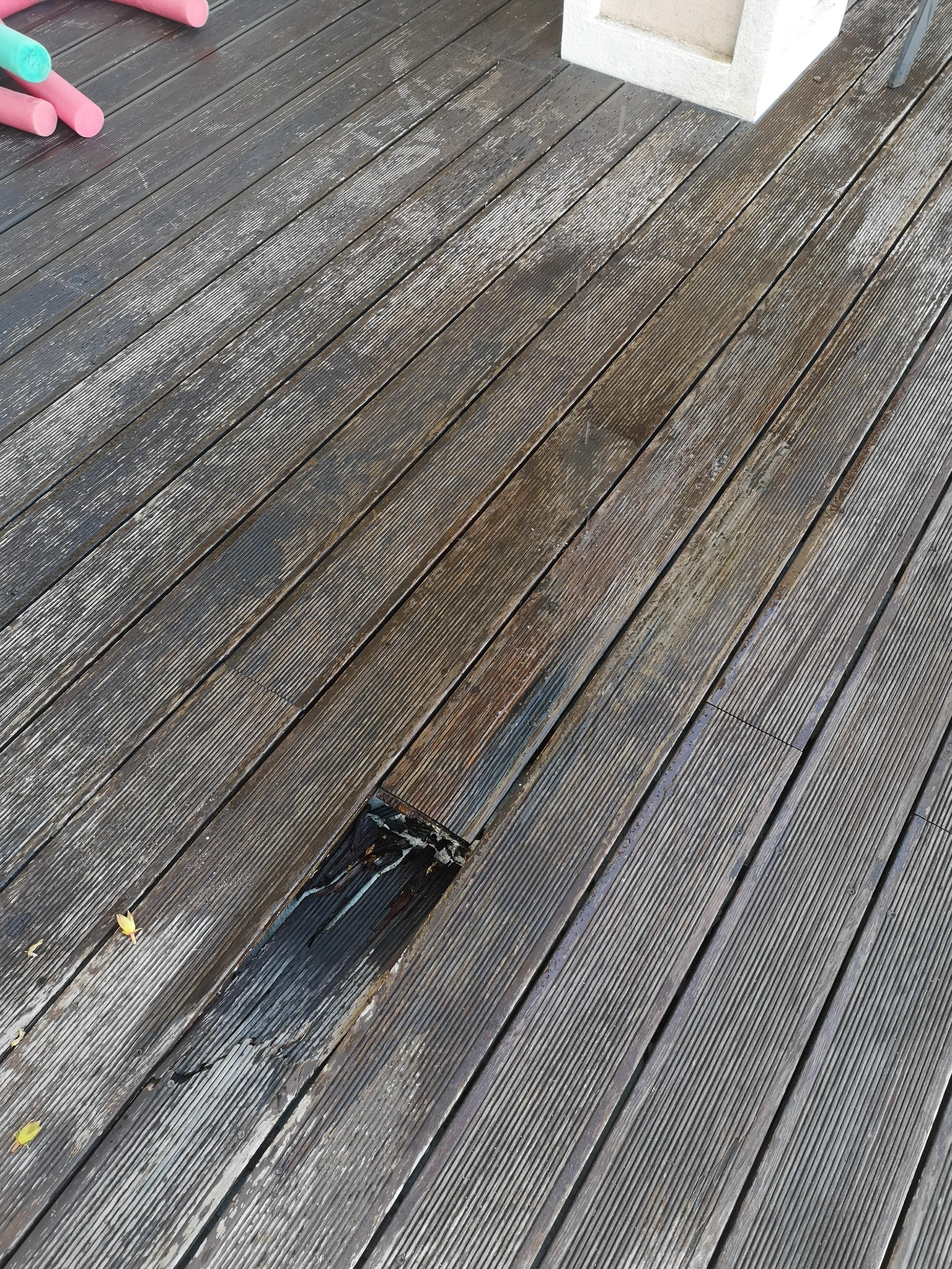 Large hole in decking with added wet area from unwanted water feature (leaking roof solar unit)