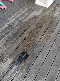 Large hole in decking with added wet area from unwanted water feature (leaking roof solar unit)