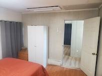 First downstairs bedroom as an example of what four other bedrooms look like. Ceilings, walls, floors all under various stages of disrepair.