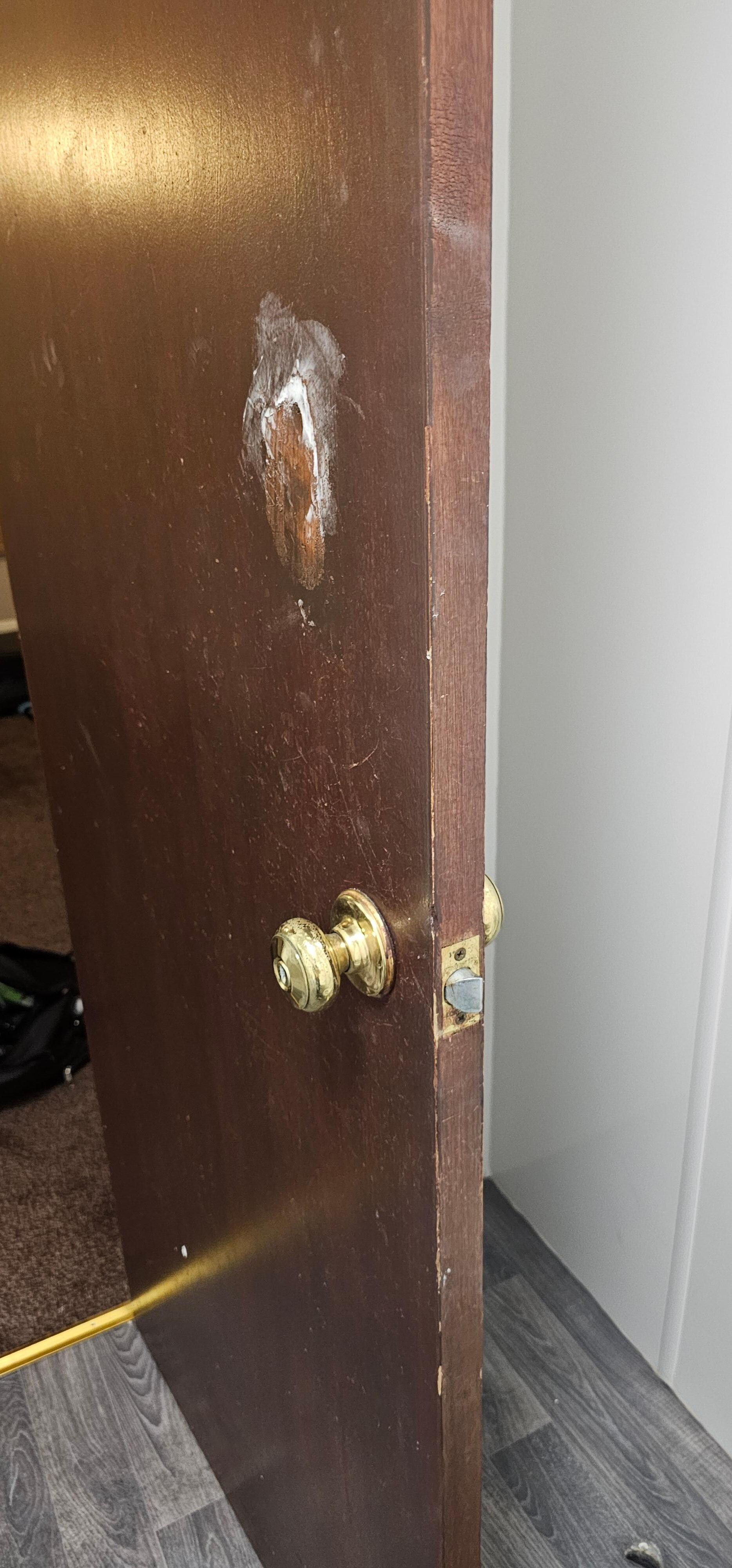 Old hole in the door, filled with polyfill from some time ago clearly