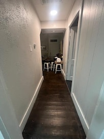 Entry into second level, leads to kitchen, sitting area, and master bedroom (door to the right) and another bedroom by front door.