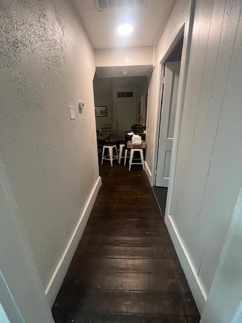 Entry into second level, leads to kitchen, sitting area, and master bedroom (door to the right) and another bedroom by front door.