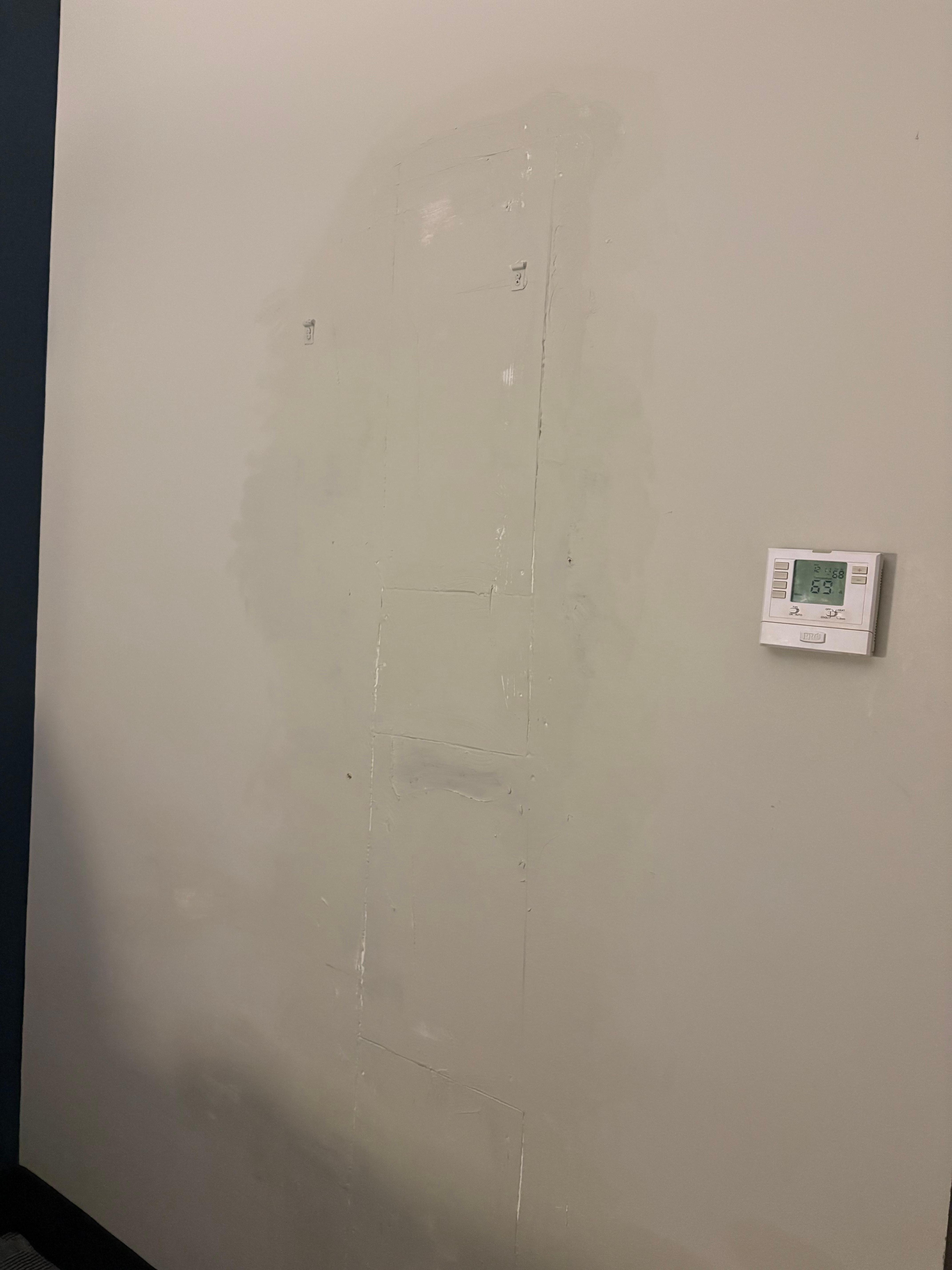 Clearly shoddily repaired wall—not the main issue but notable 