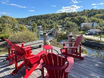 An outdoor deck, perfect for morning coffee, overlooking the water including a lobster shack & boat
