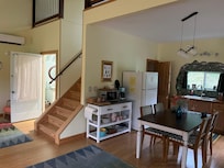 Interior of kitchen, living room, stairs to the loft, and door to the bathroom