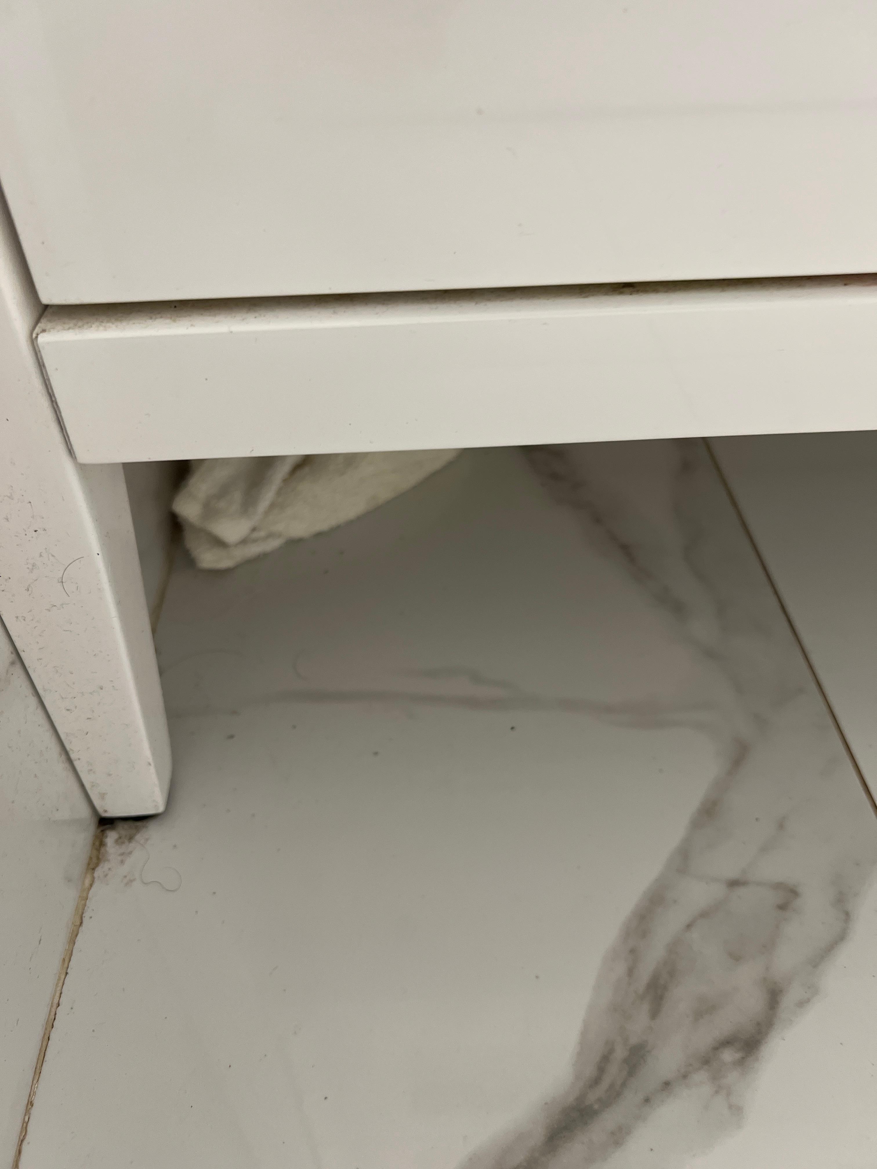A hand towel left under the vanity. 😰