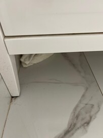 A hand towel left under the vanity. 😰