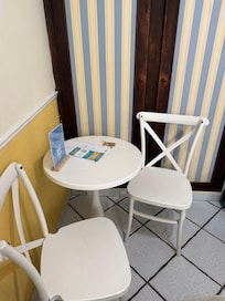 Table and chairs in front of closet.
