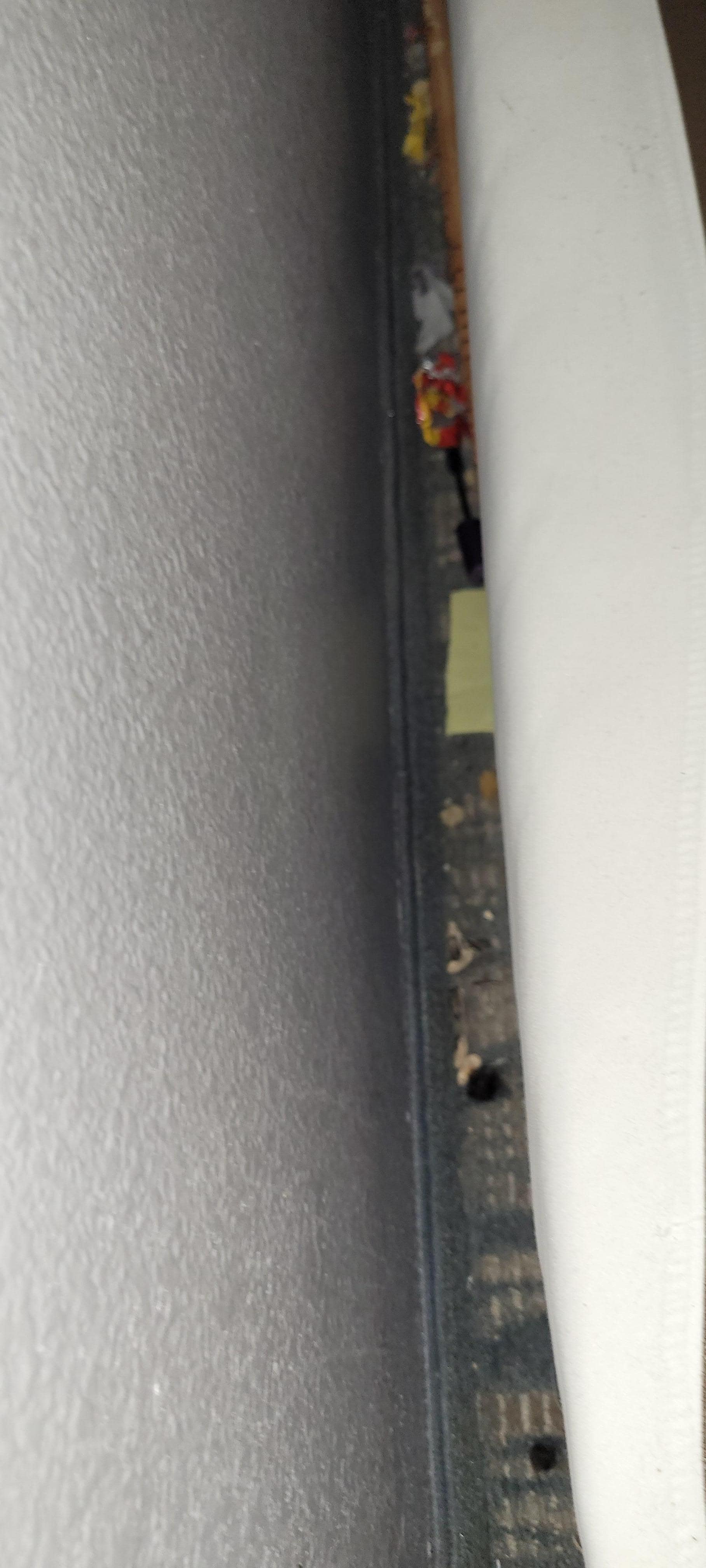 Behind the bed below your head.