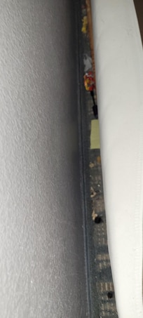 Behind the bed below your head.