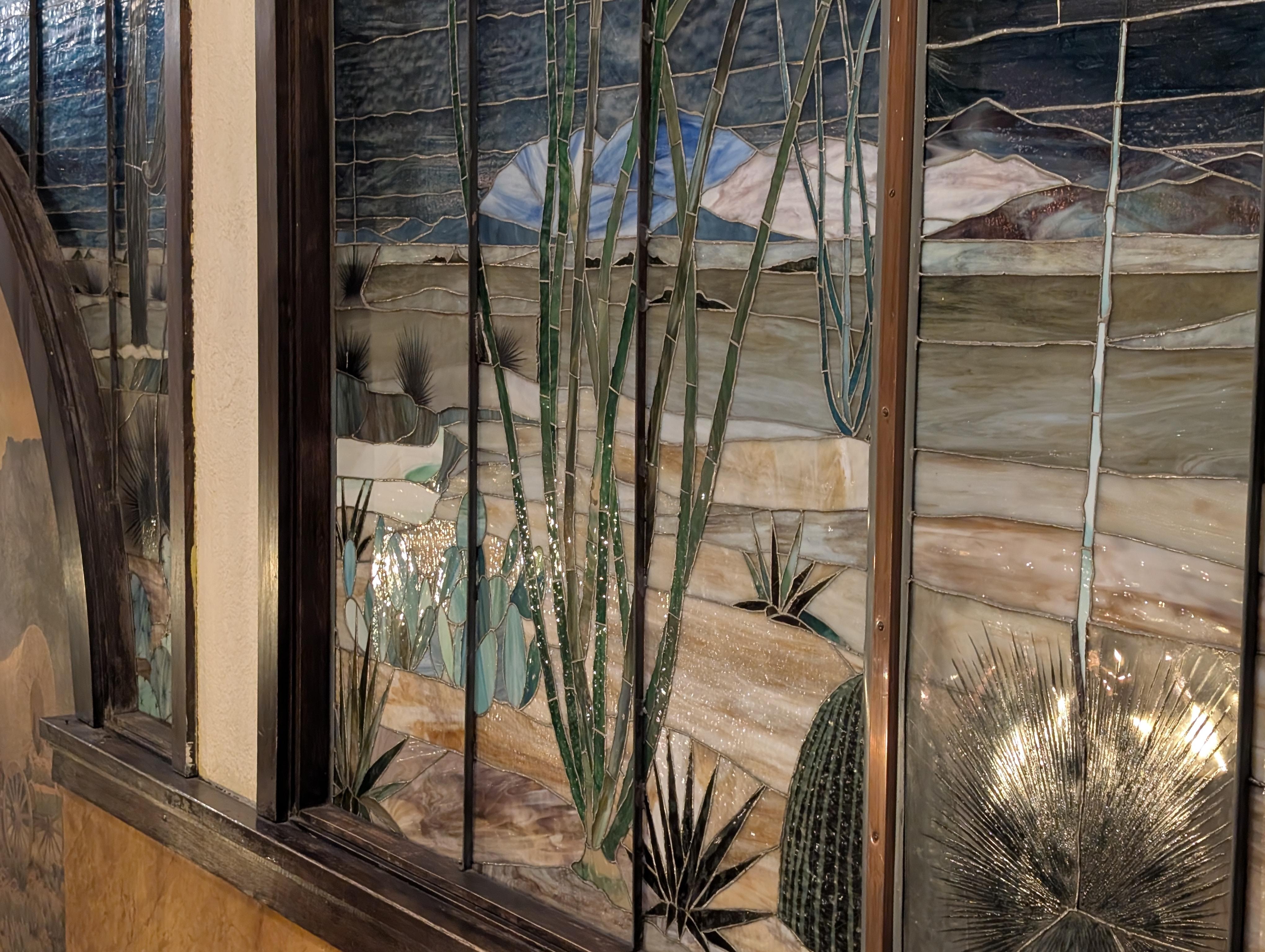 Stain glass- large and beautiful - several mounted on wall above staircase.