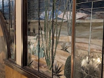 Stain glass- large and beautiful - several mounted on wall above staircase.