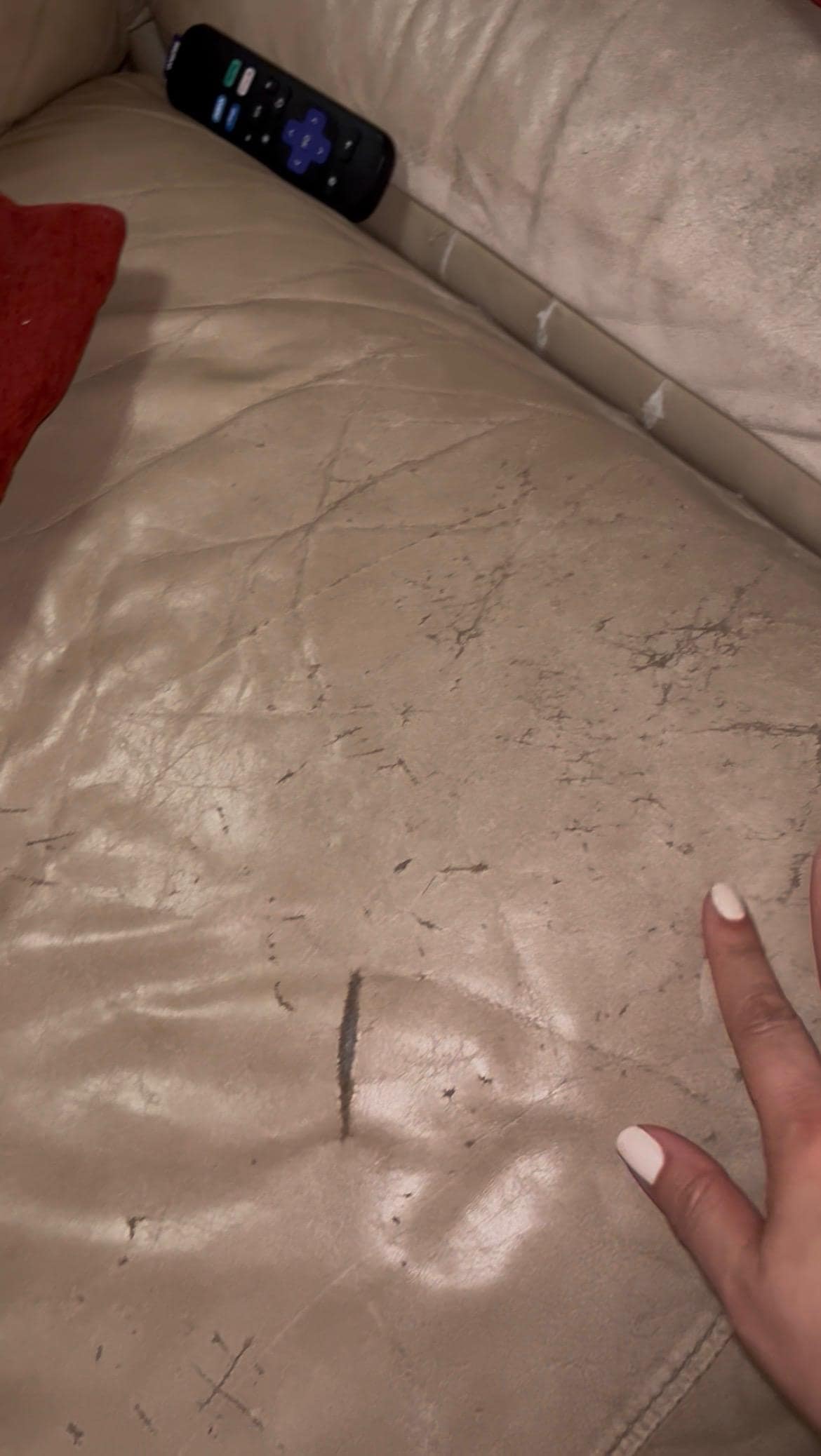 Worn out couch with torn couch cushions. 