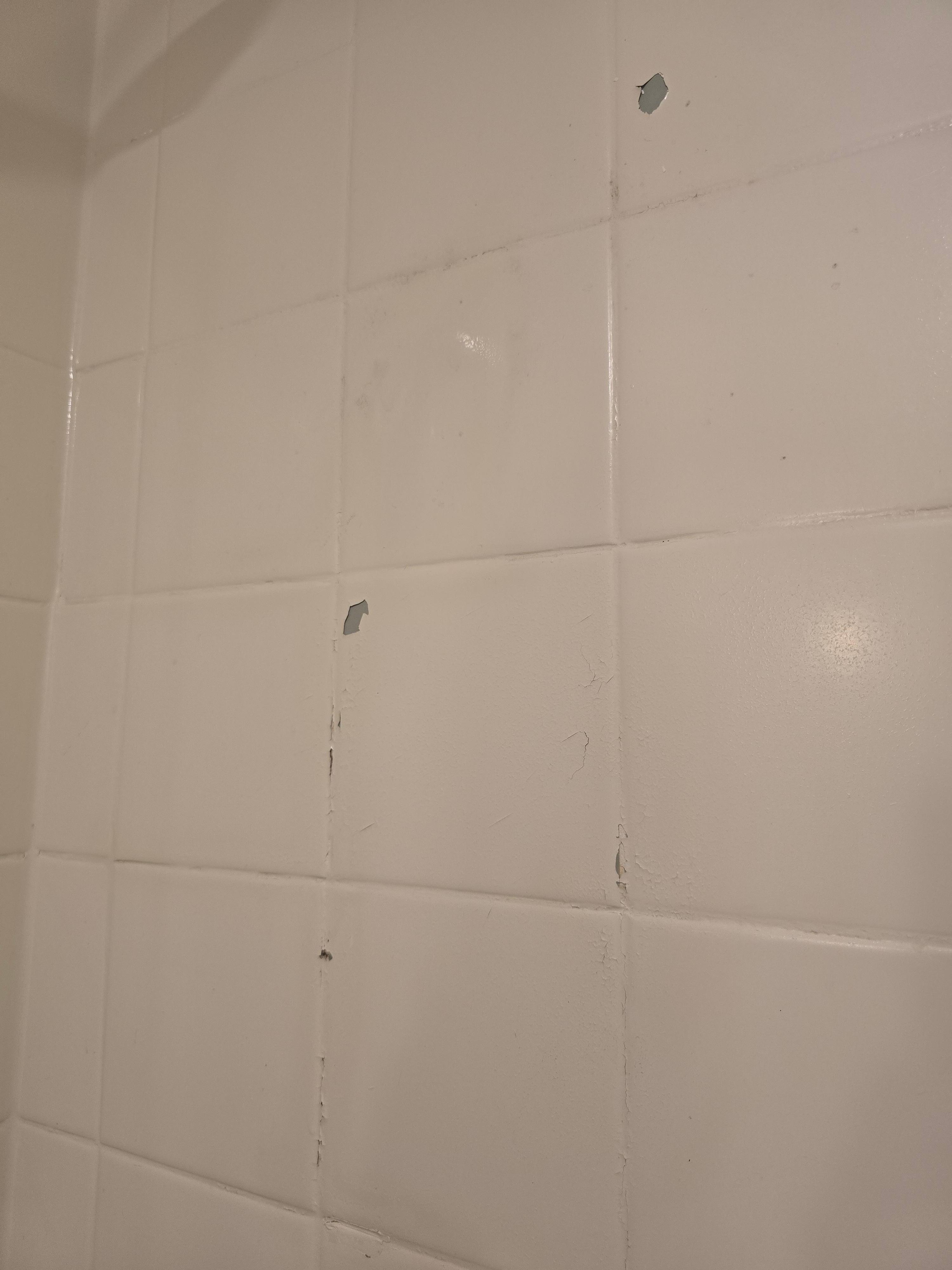 Paint peeling off tiles in bathroom