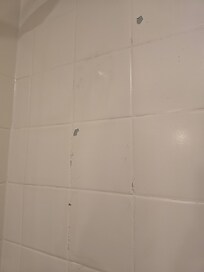 Paint peeling off tiles in bathroom