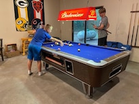 Playing pool in the game room.