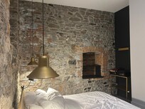 Authentic stone walls in the bedroom and main area kitchen living room.